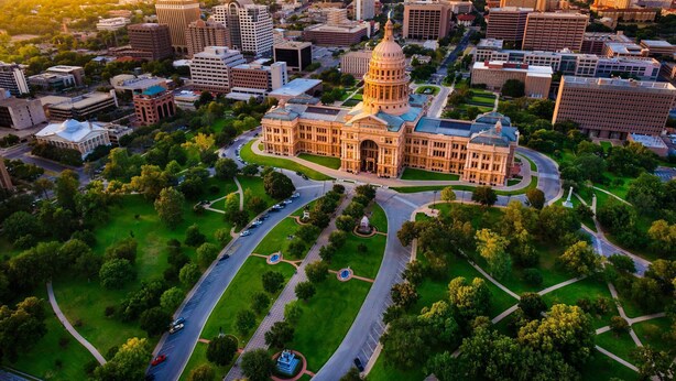 An aerial view of a cityscape with a prominent historic building with a dome, surrounded by green spaces and modern buildings. - Time to Grill with Gas BBQ, Smoker, with Big Yard. Large office and new appliances (Round Rock)