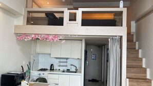 A compact, modern apartment with a loft bedroom, a kitchenette, and a staircase. - Seoul Apartment. Great location, close to tourist attractions, Wi-Fi. (Seoul)