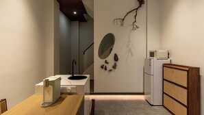 A modern kitchen with a built-in microwave, a sink, and a wooden cabinet. - Zen Den Design (Shantou)