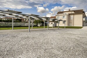 A building with a beige exterior, a flat roof, and a visible balcony. - GuestHost - Mare Monti Apartment 6 (Dogana)