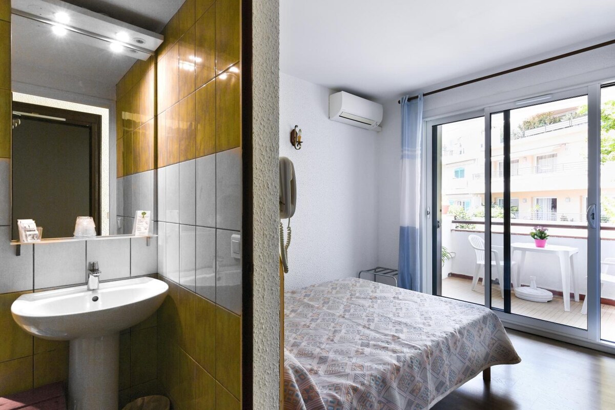 A modern bathroom with a sink, mirror, and a shower area.