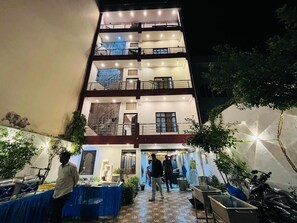 A multi-story building with balconies, a staircase, and outdoor seating areas. - Krishna Villa  (Varanasi)