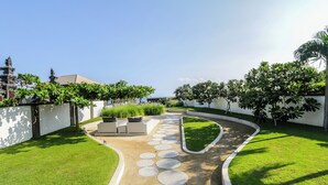 A landscaped pathway with circular stepping stones leading to a seating area.