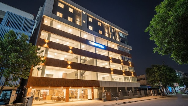 A multi-story hotel with a prominent 'Fachhotels' sign, large windows, and a modern architectural design. - FabHotel Airport Stay Inn - Near Kempegowda Airport (Bangalore)
