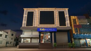 A modern building with a 'fab hotels' sign, featuring a prominent entrance and a staircase leading to the ground floor. - FabHotel Indian Suites - Krishnarajapuram (Bangalore)