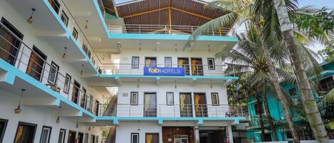 A multi-story building with a sign reading "fabHOTELS".