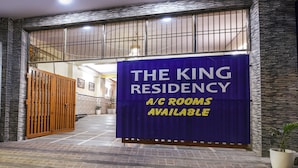 A hotel entrance with a sign stating "The King Residency A/C rooms available." - Fabhotel The King Residency (New Delhi)