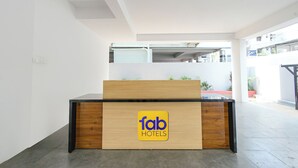 A reception desk with a 'fab hotels' sign, a modern interior design, and a view of the outside. - Fabhotel Navya Grand (Hyderabad)