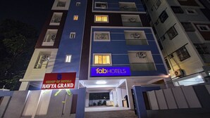 A multi-story hotel building with a sign for 'Group of Hotels Navya Grand'. - Fabhotel Navya Grand (Hyderabad)