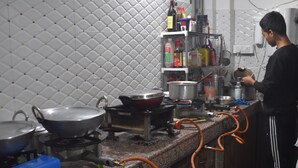 A kitchen with granite countertops, a gas stove, and various cooking utensils. - Elysian Home (Shillong)