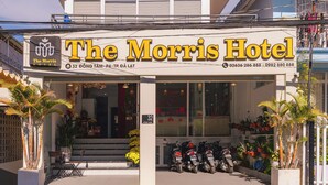 The Morris Hotel with a clear sign, a welcoming entrance, and a row of parked motorcycles outside. - The Morris Central Hotel - O'TEL (Xuan Huong - Da Lat)