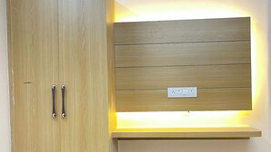 A wooden wardrobe with a built-in light shelf and a power outlet. - Host varanasi (Varanasi)