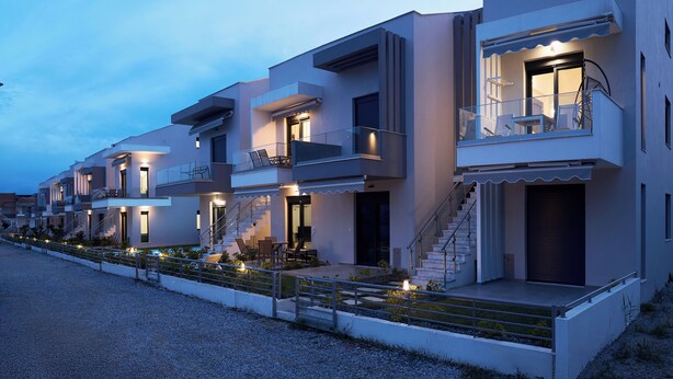A modern multi-story residential building with balconies, staircases, and outdoor seating areas. - Erato Residential Complex-Two Bedroom Loft No Pool Access (Kavala)