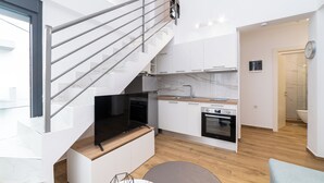 A modern kitchen with a built-in oven, a stainless steel sink, and a wooden countertop. - Erato Residential Complex-Two Bedroom Loft No Pool Access (Kavala)