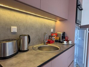 Fridge, coffee/tea maker, cookware/dishes/utensils