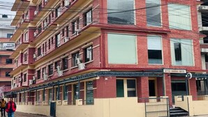 A multi-story building with a sign for 'Little Buddha Hotel Pvt. Ltd.' on the top floor. - Little Buddha Hotel Pvt. Ltd (Lumbini)