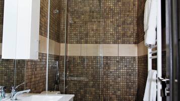 Shower, hair dryer, slippers, towels