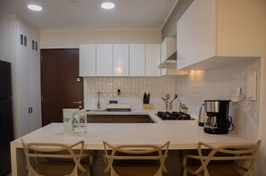 Fridge, microwave, stovetop, coffee/tea maker