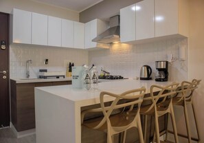 Fridge, microwave, stovetop, coffee/tea maker