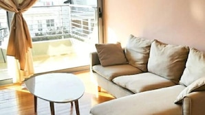 A modern living room with a sofa and a small table. - Brand new flat in the amazing area of       Alimos (Alimos)
