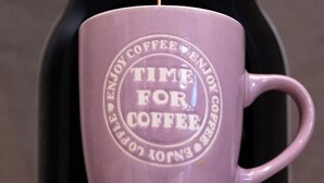 A purple mug with the inscription "TIME FOR COFFEE" being filled from a coffee machine. - Nancy   s studio at metro Petralona (Athina)