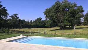 A rectangular swimming pool with a tiled deck and lounge chairs. - Beaujolais house with charm, pool, fireplace (Gleizé)