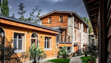 Un edificio de madera con escalones de piedra y un sendero pavimentado.