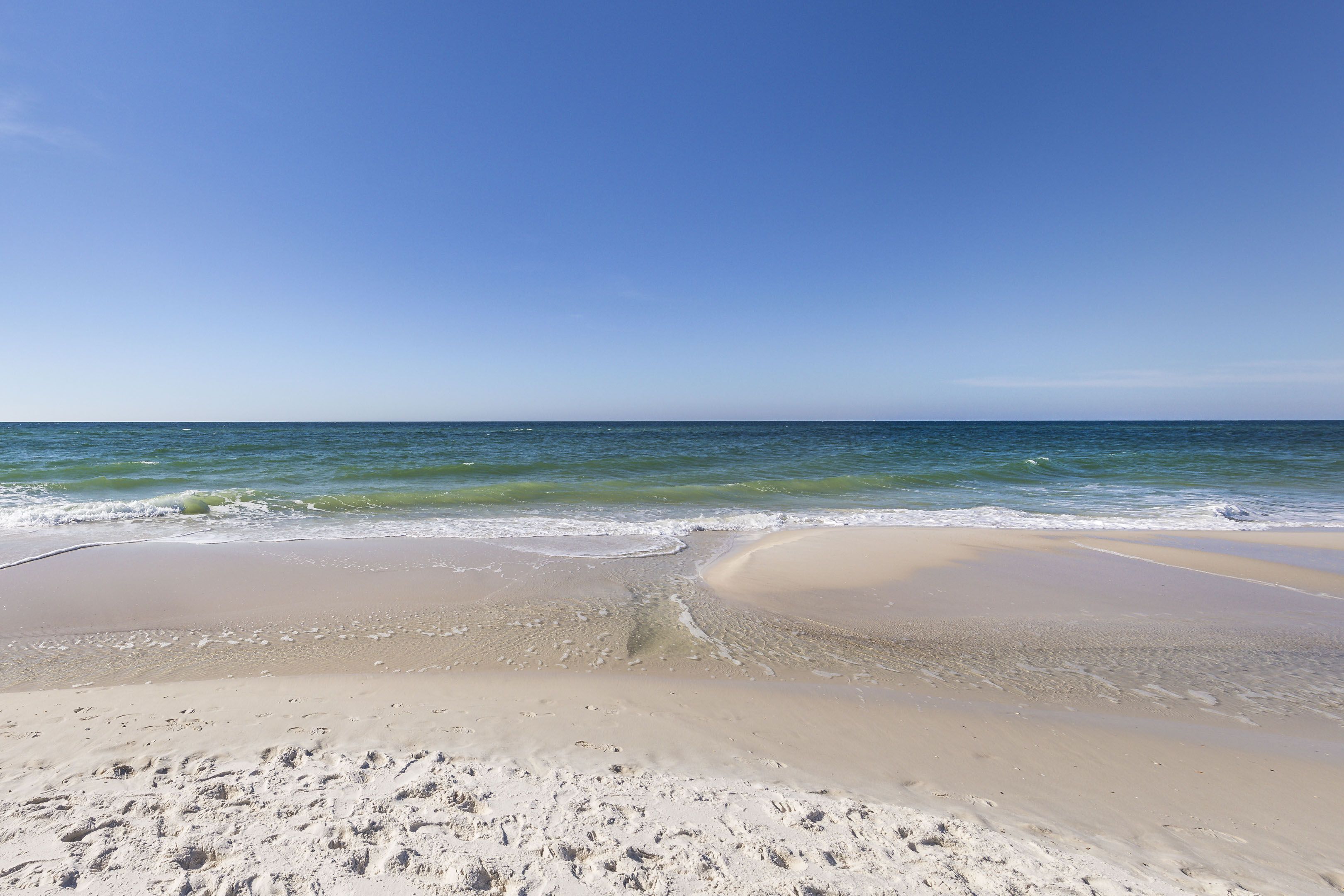 A beach with clear skies and calm waters.