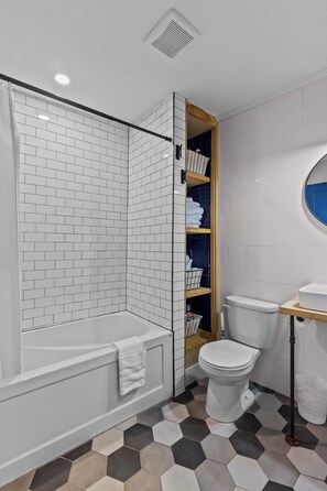 A sparkling clean full bathroom with a subway tile shower and tub combination. - Harbour View Rowhome Signal Hill & Downtown (St. John's)