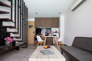 Exclusive Apartment, Balcony, Pool View | Living room | Flat-screen TV