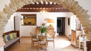 A cozy dining area with a round table, wooden chairs, and a stone archway. - Vacation rental house with pool ALTHEN LES PALUDS  LS6-71 (Althen des Paluds)