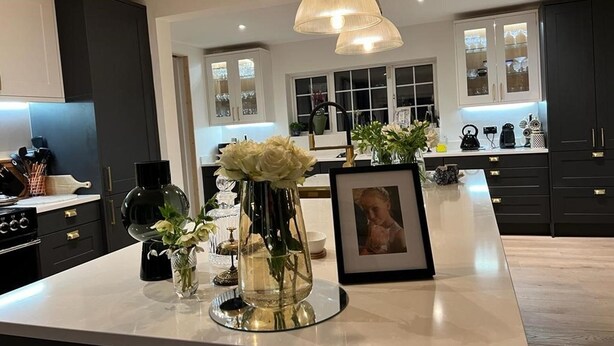 A modern kitchen with dark cabinetry, a marble countertop, and pendant lighting. - Spacious 5-bed House - Garden, Parking & Bbq (Newcastle Upper)