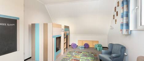 A child's playroom with a chalkboard, wooden play structures, and a colorful mat.