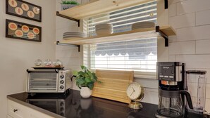 A kitchen with a toaster, a clock, a coffee maker, and a potted plant. - San Antonio Home 2 Mi to Dtwn, Swim Spa! (San Antonio)