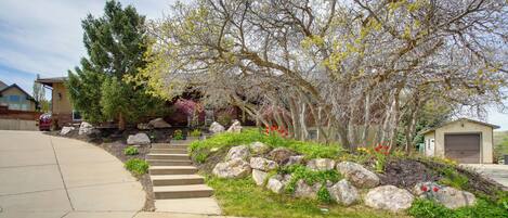 A residential driveway with a stone pathway leading to a garage.