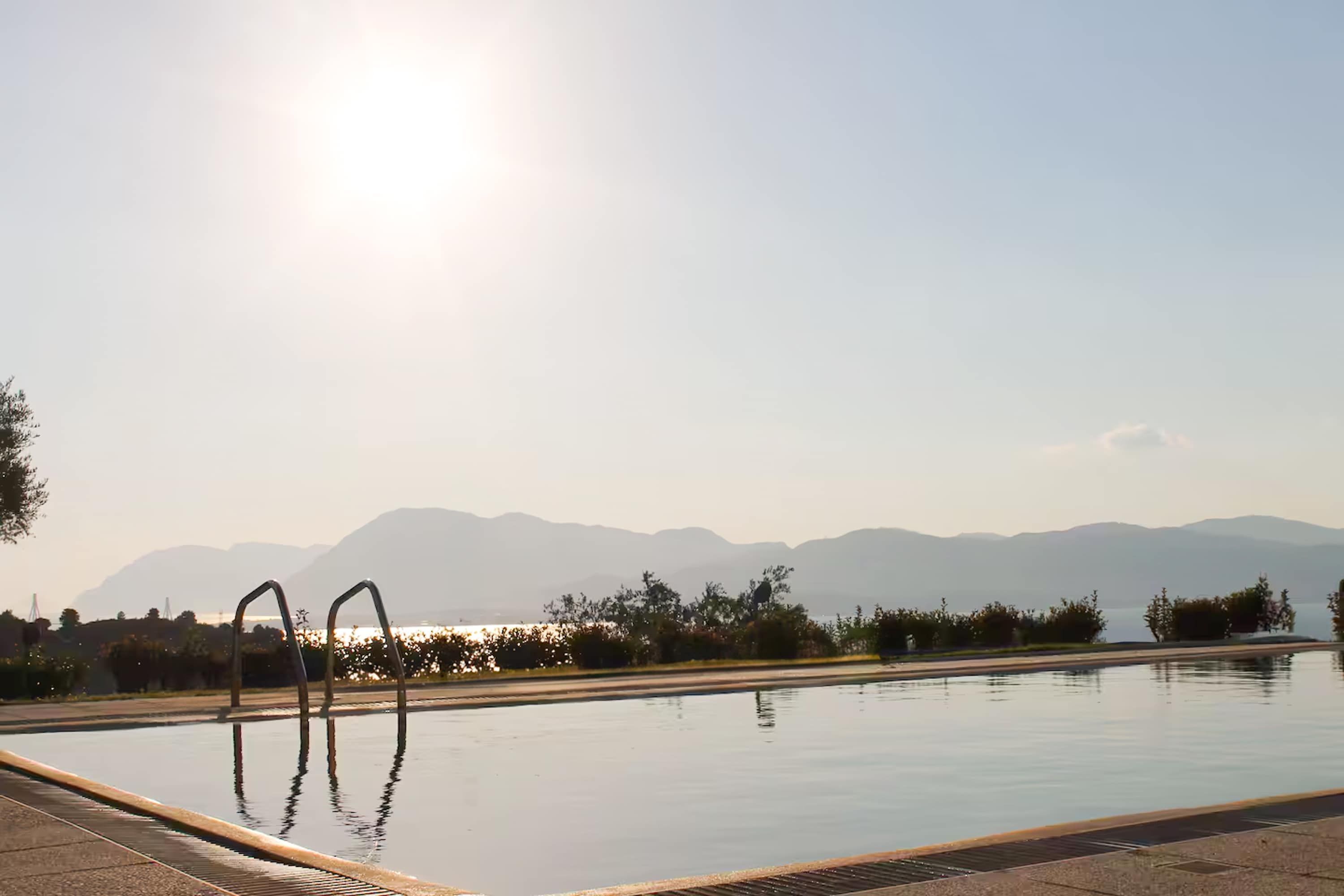 A swimming pool with a clear view of mountains in the background.
