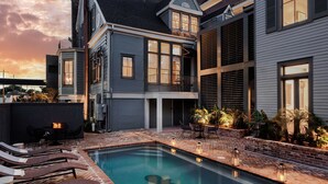 A modern house with a pool, outdoor seating, and a balcony. - The Estella, 6BR Garden District Suite,Shared Pool (New Orleans)