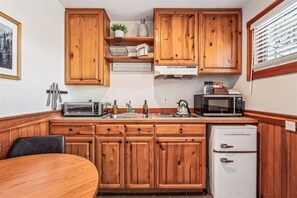 Fridge, microwave, coffee/tea maker, cookware/dishes/utensils