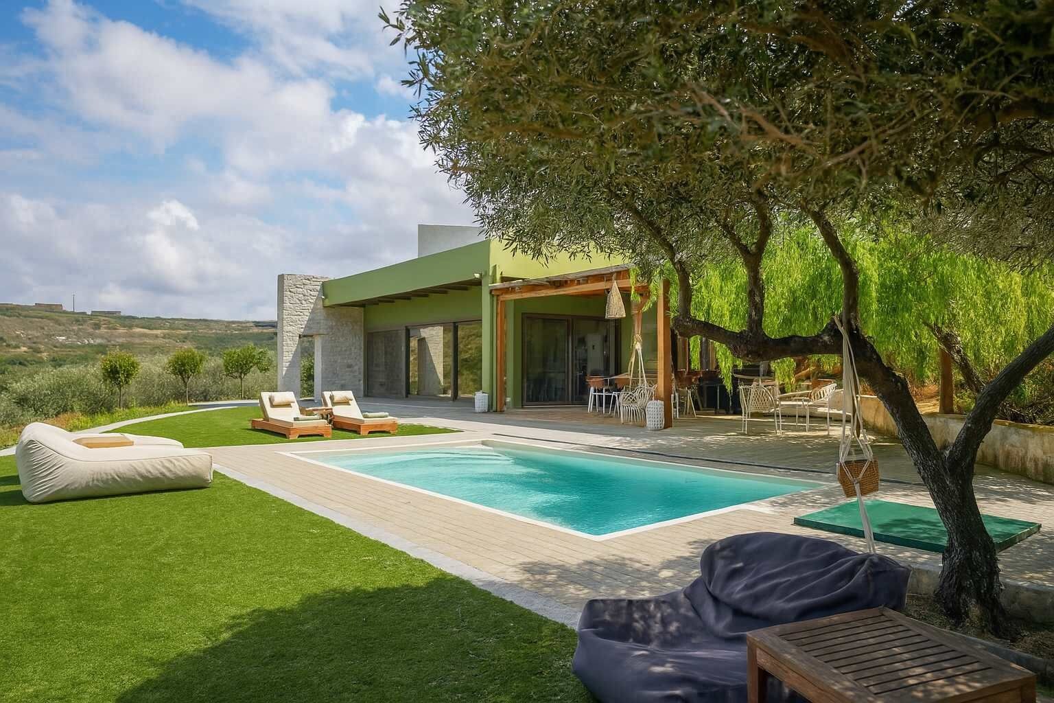 A modern outdoor pool area with lounge chairs and a dining set.