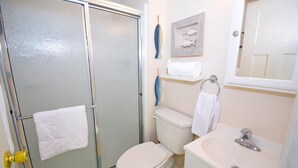 A bathroom with a glass shower enclosure, a toilet, a sink, and a towel rack. - Sea Raider Iv 303 3 Bedroom Condo (Ocean City)
