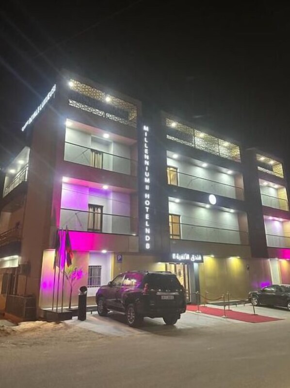 A multi-story hotel with a prominent sign reading "Millennium Hotel."