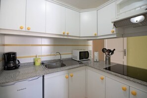 Fridge, microwave, coffee/tea maker, cookware/dishes/utensils