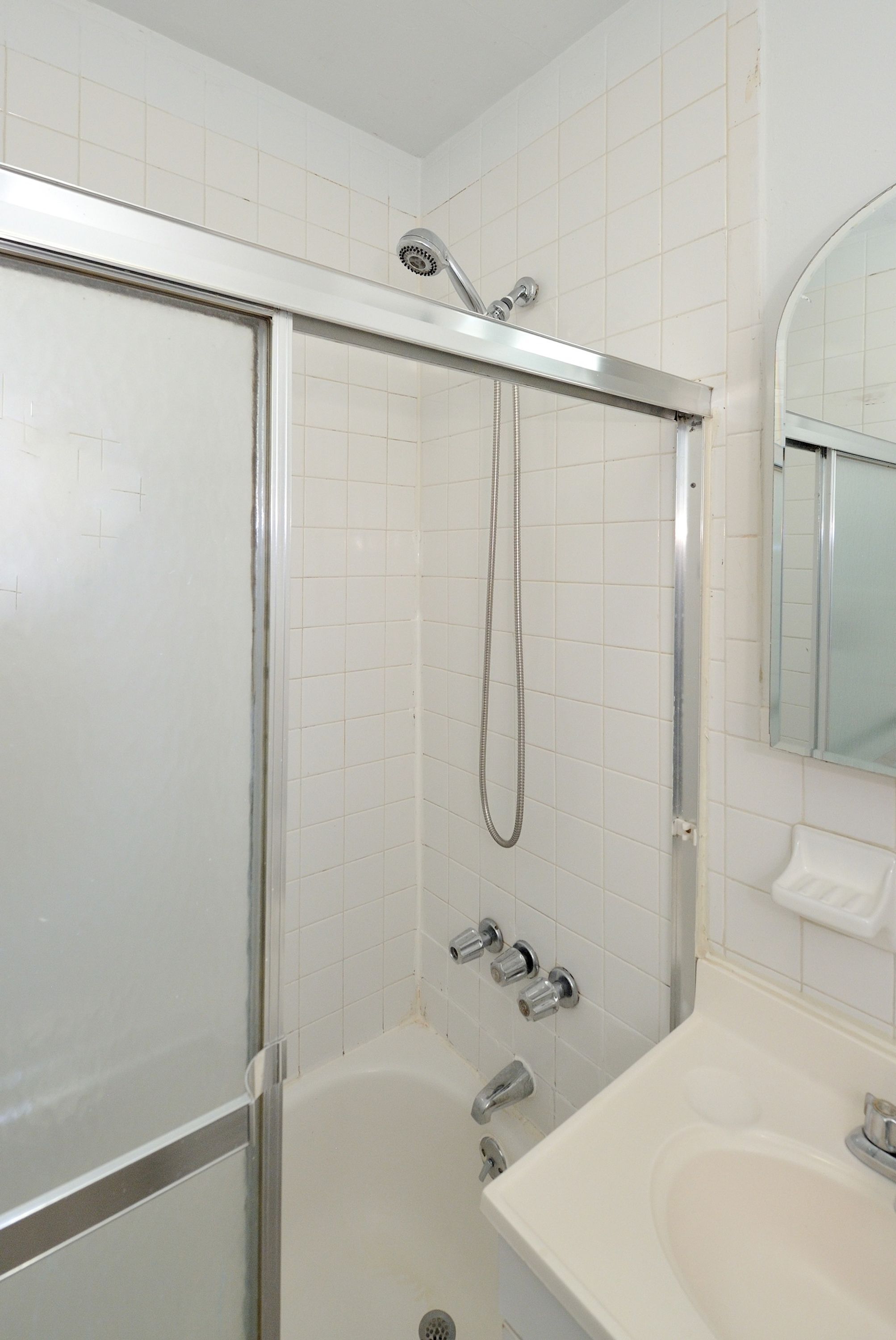 A bathroom with a shower, a bathtub, and a sink.