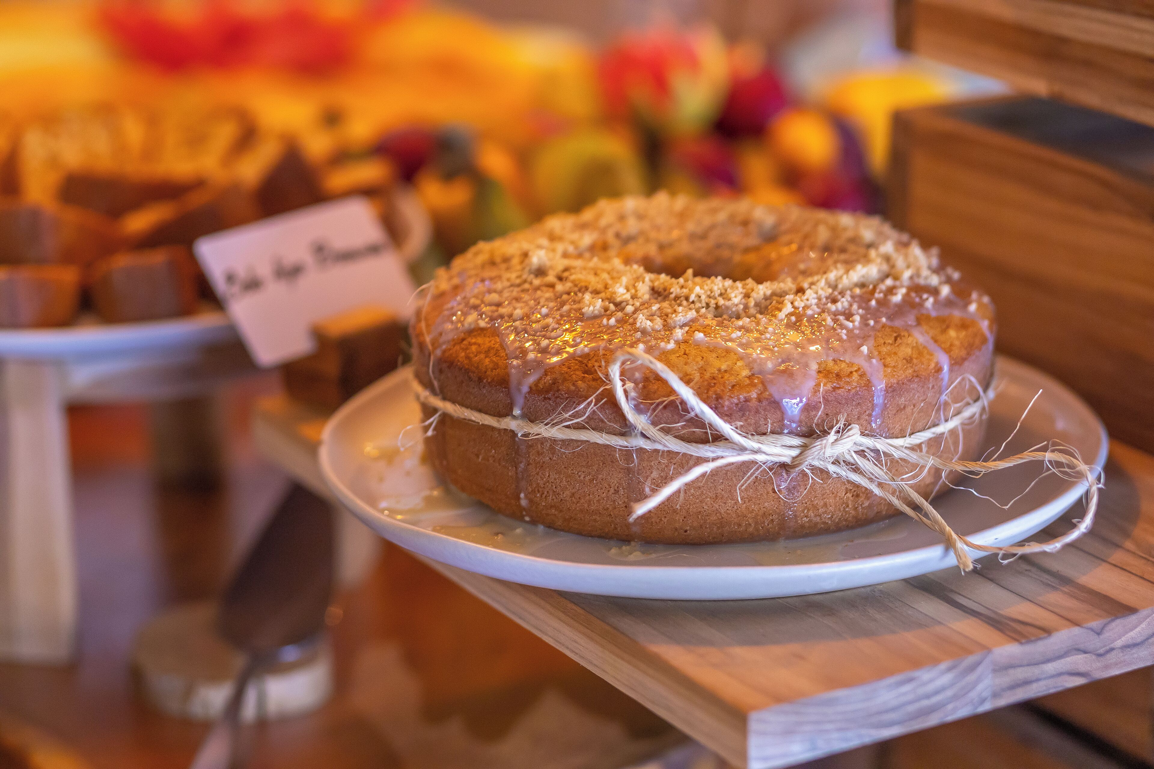 A cake on a wooden table with a label.