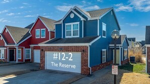A row of houses with a garage labeled "#12-2 The Reserve."