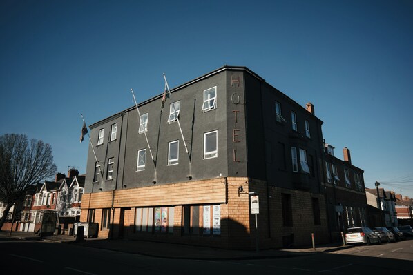 A corner building with a sign reading "HOTEL" on the side. - Hotels 247 (Newport)