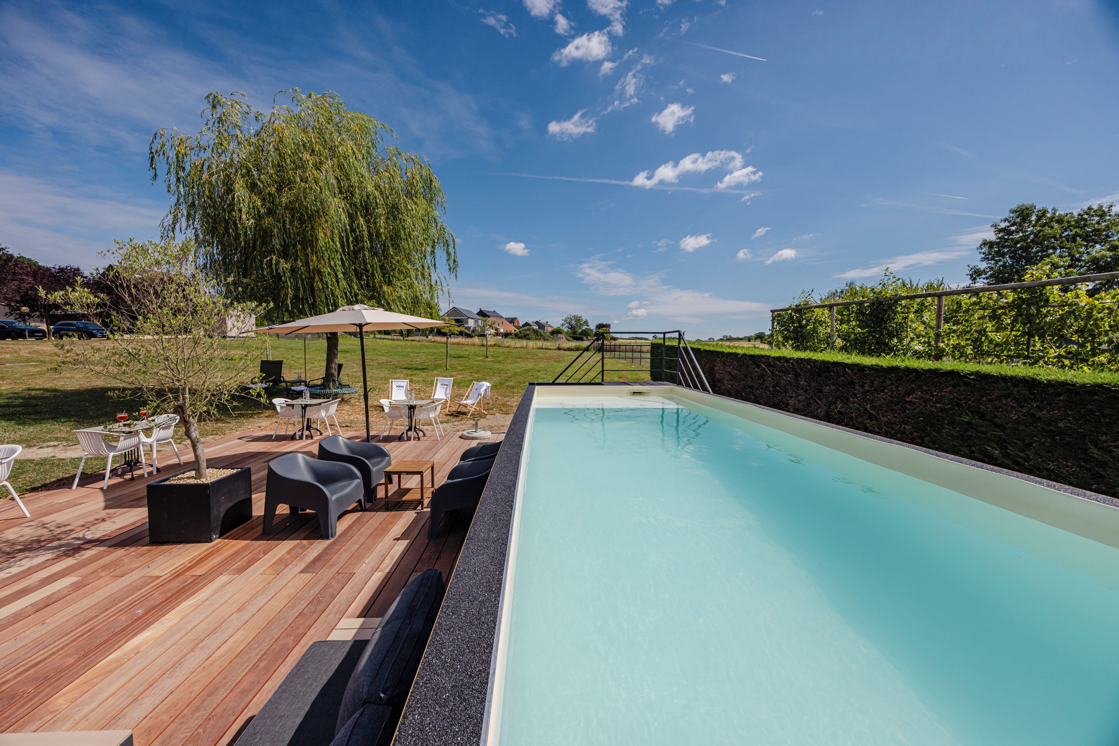 Seasonal outdoor pool, open 10:00 AM to 9:00 PM, pool umbrellas