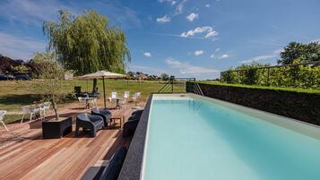 Seasonal outdoor pool, open 10:00 AM to 9:00 PM, pool umbrellas