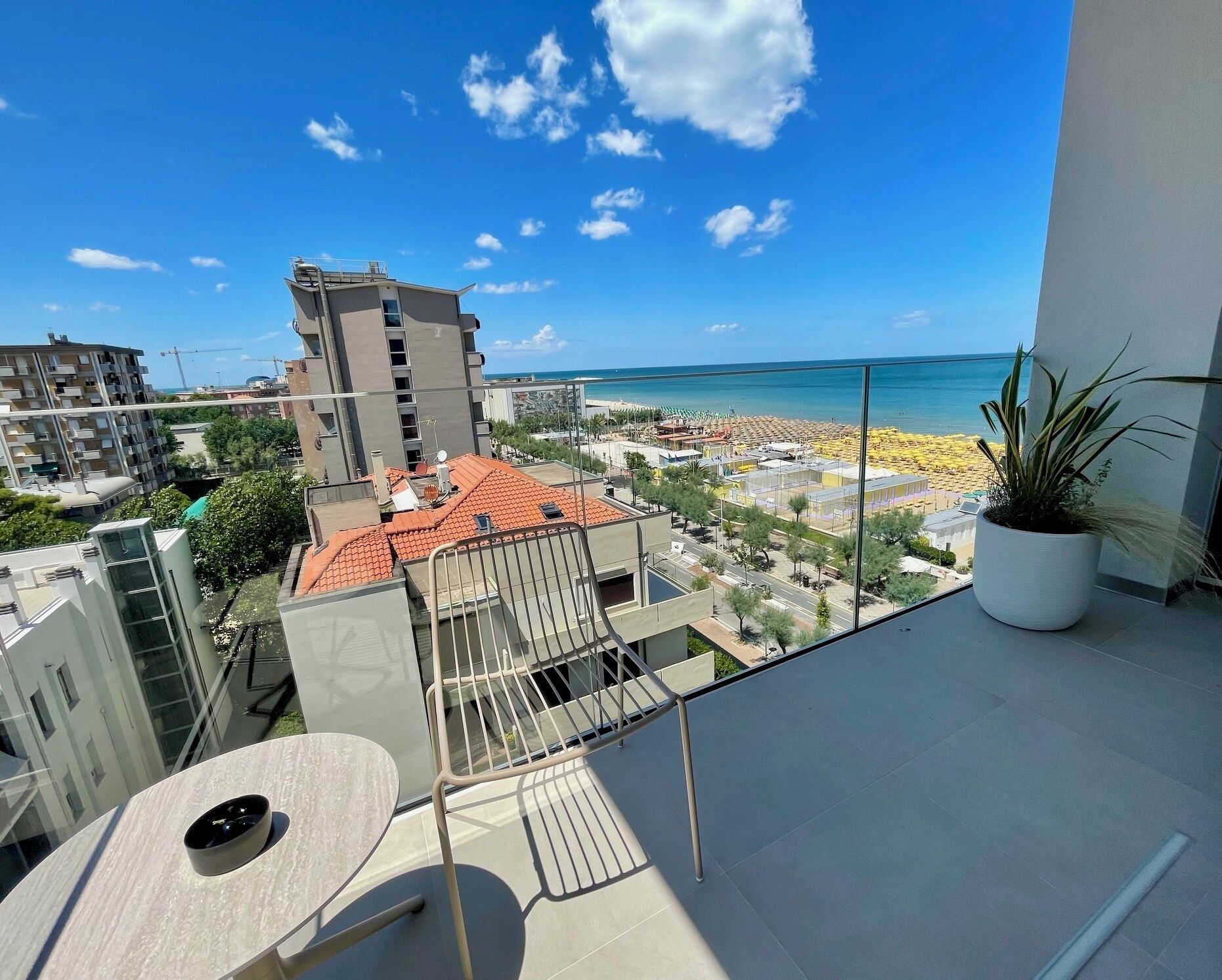 A balcony with a view of a beach and ocean.