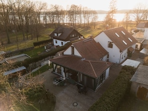 A residential area with houses, a patio, and a view of a body of water.